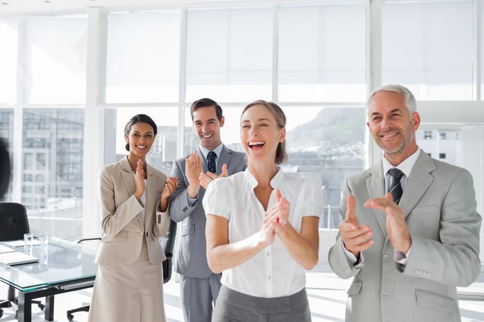 Group of business people applauding together in the meeting room